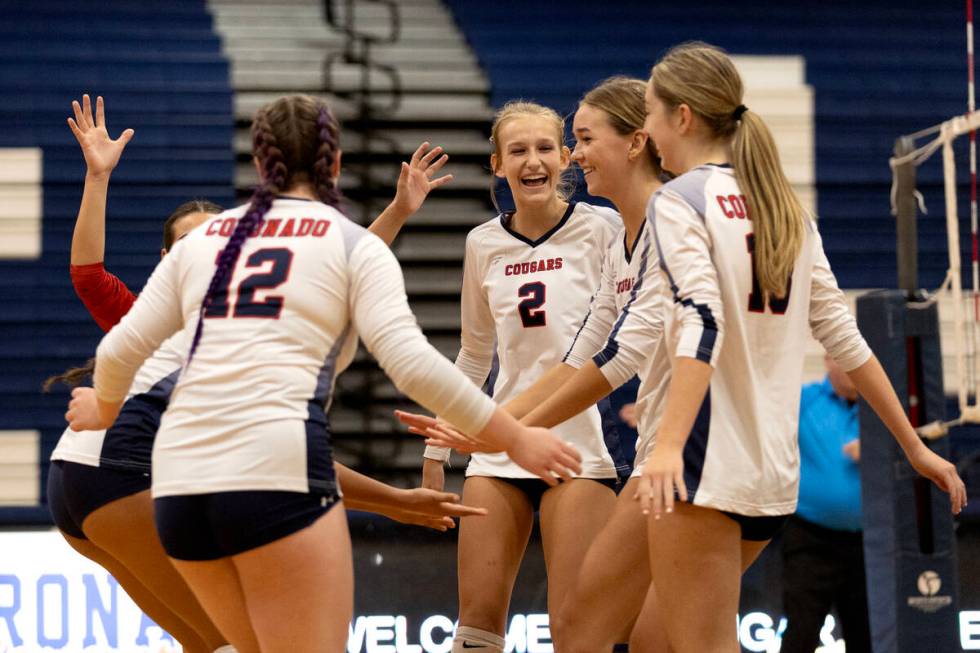 Coronado gather to celebrate a point during a high school volleyball game against Silverado at ...