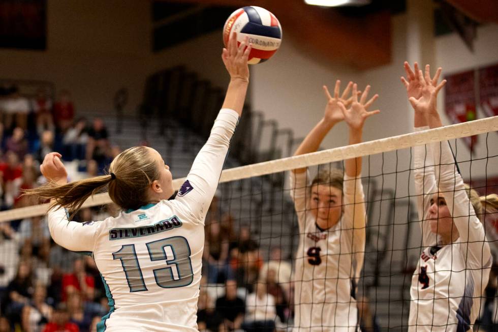 Silverado’s Leaf Riccio (14) spikes to Coronado’s Rachel Purser (9) and Gentry Ob ...