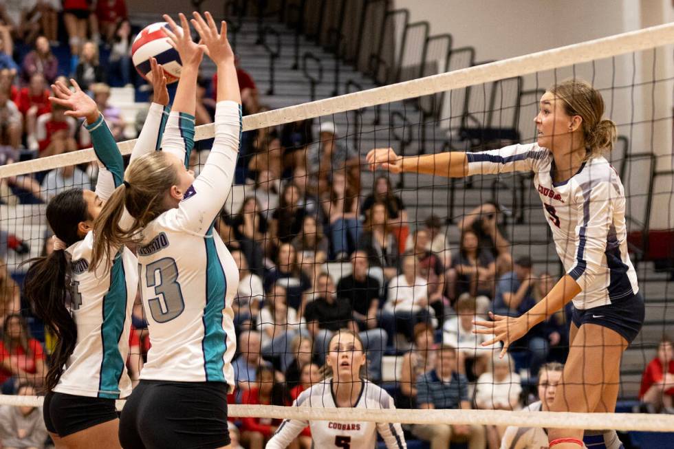 Coronado’s Rachel Purser (9) spikes while Silverado’s Isabella Hemingway (14) and ...