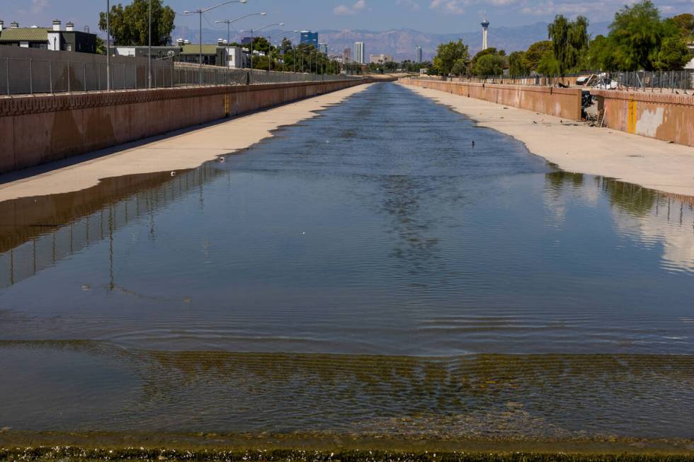 Water in a wash moves along at South Nellis Blvd., upstream is where an individual was swept in ...