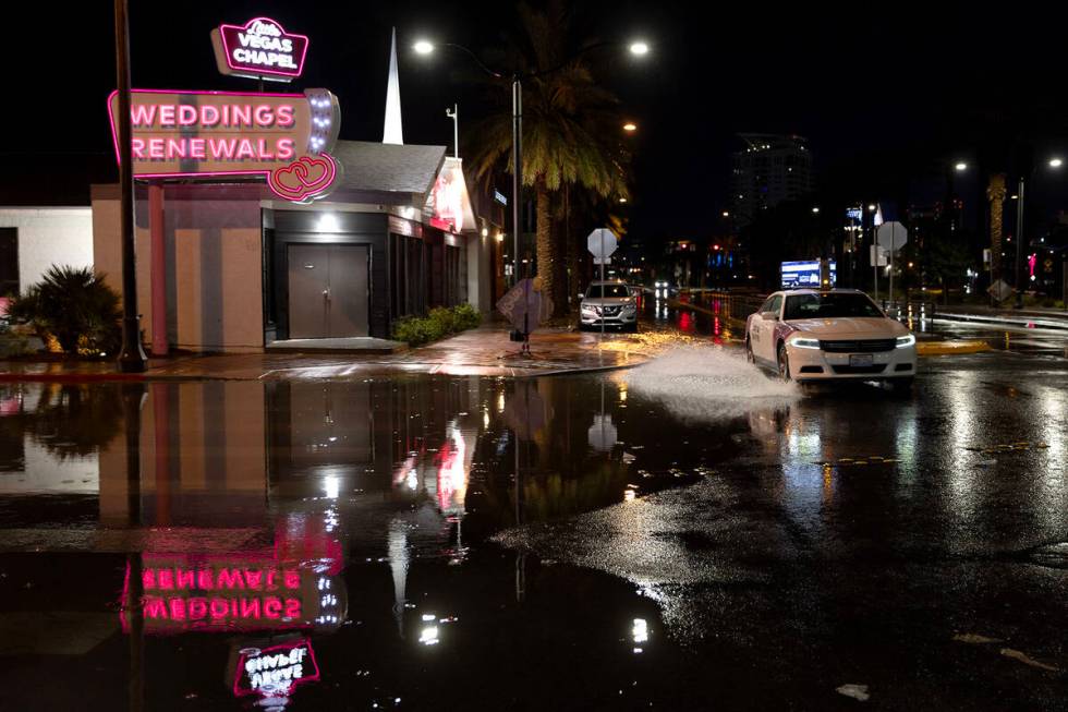 A taxi drives through flood waters down South 3rd Street at East Imperial Avenue on Wednesday, ...