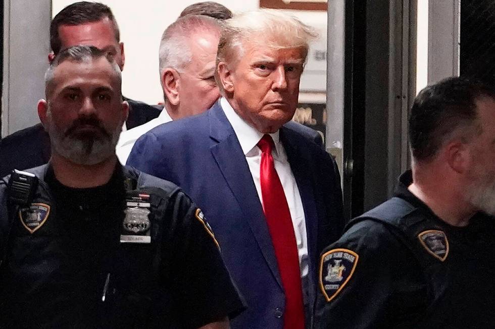 FILE - Former President Donald Trump is escorted to a courtroom, April 4, 2023, in New York. Do ...