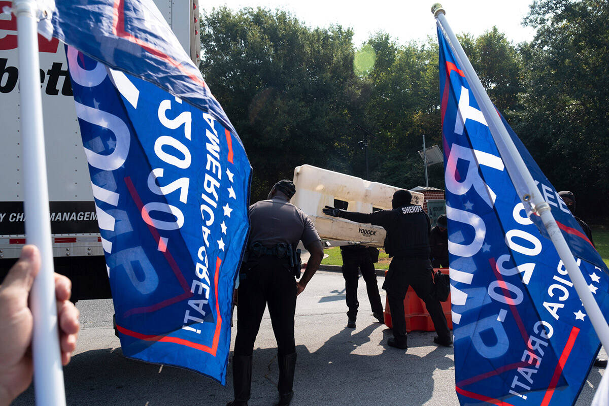 Officials set up barriers in front of the Fulton County jail as supporters of former President ...