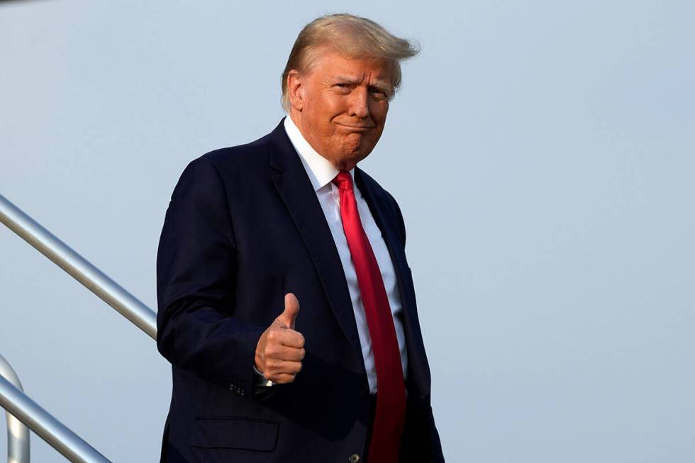 Former President Donald Trump steps off his plane as he arrives at Hartsfield-Jackson Atlanta I ...