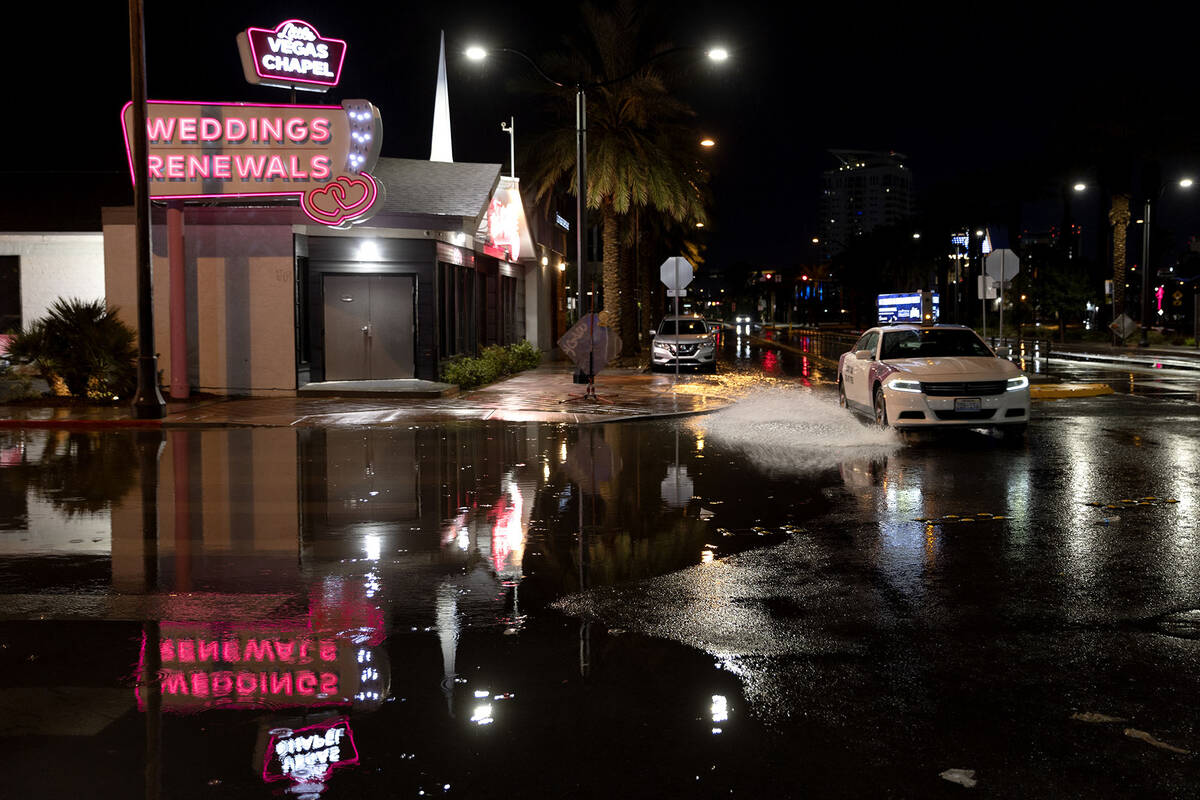 A taxi drives through flood waters down South 3rd Street at East Imperial Avenue on Wednesday, ...