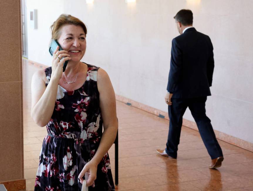 Colleen Beyer, daughter of murder victim Sharon Causse Randolph, calls her husband outside cour ...