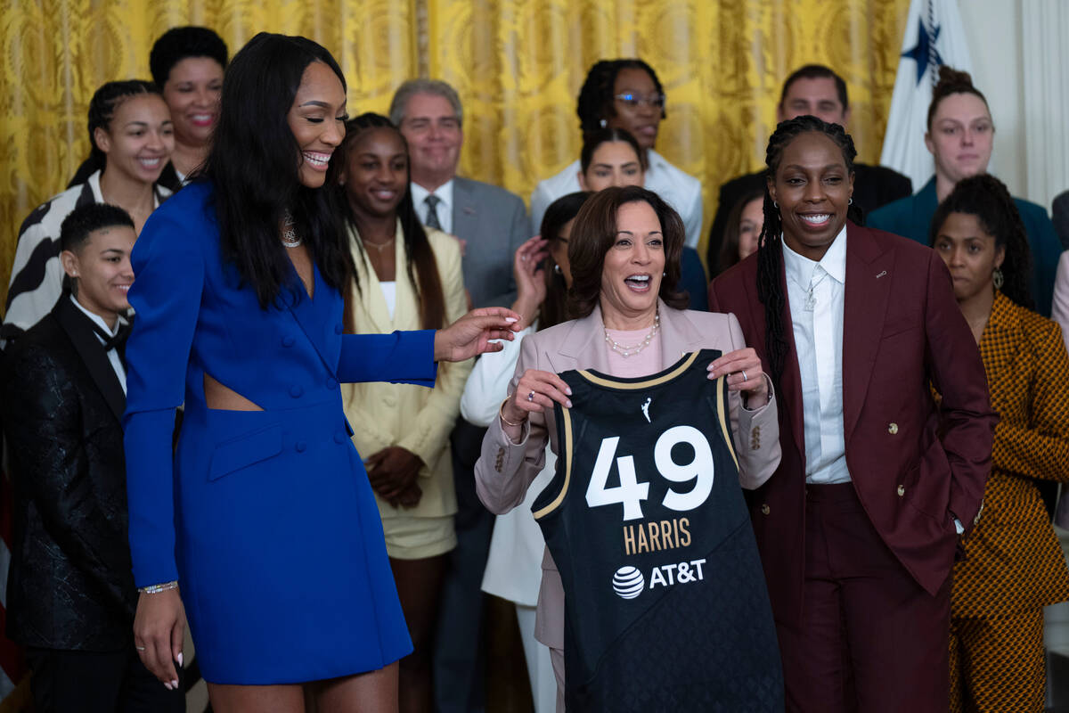 Vice President Kamala Harris is presented with a Las Vegas Aces jersey by Aces' A'ja Wilson, le ...