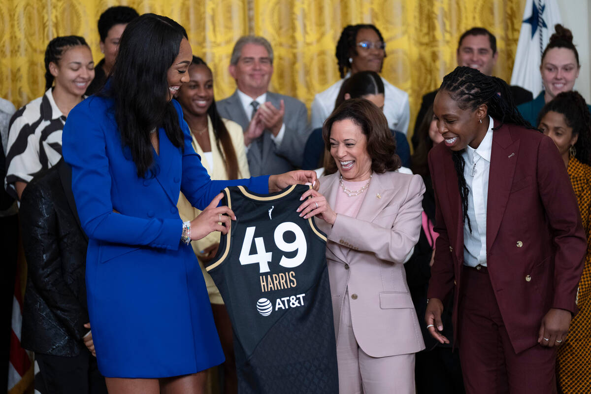 Vice President Kamala Harris is presented with a Las Vegas Aces jersey by Aces' A'ja Wilson, le ...