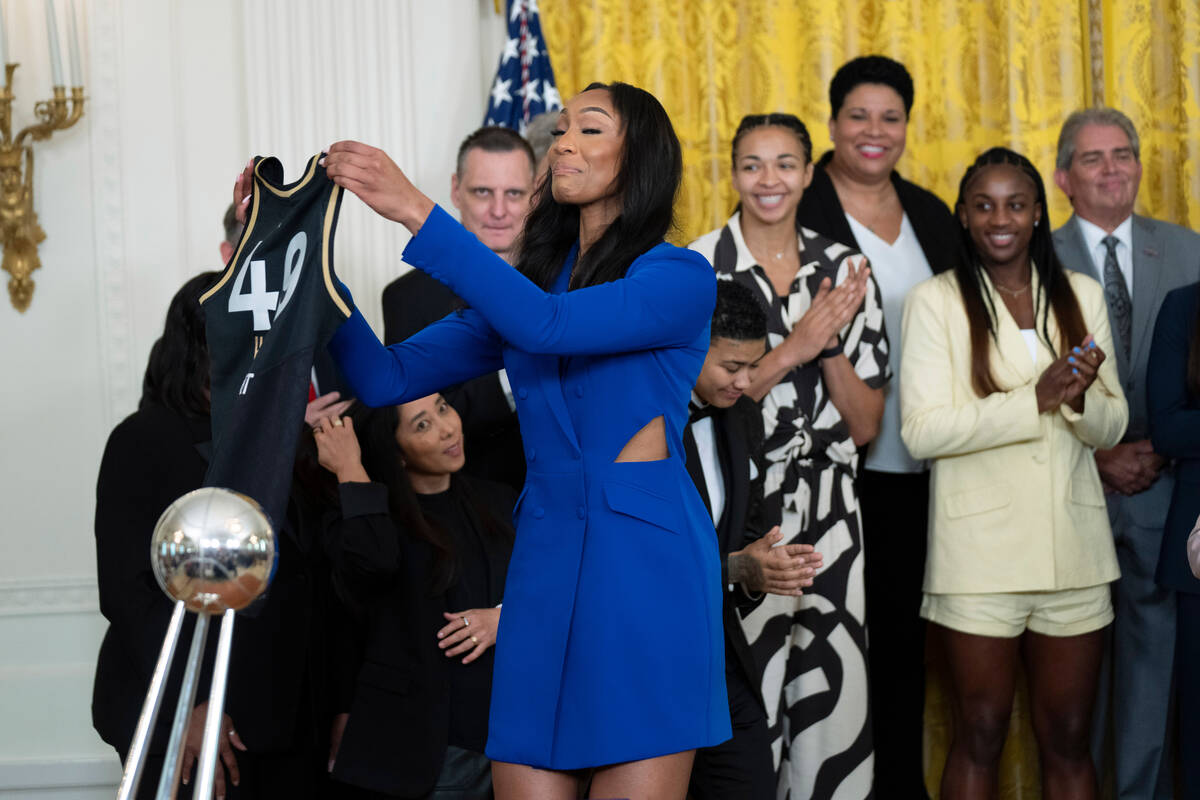 Aces forward A'ja Wilson, shows the Las Vegas Aces jersey the team is presenting to Vice Presid ...