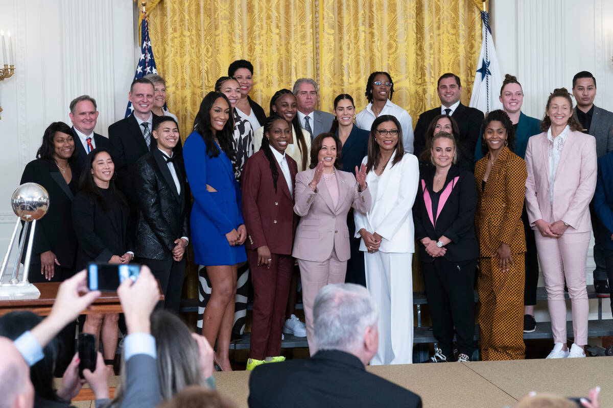 Vice President Kamala Harris, center, poses with the Las Vegas Aces WNBA team during a ceremony ...
