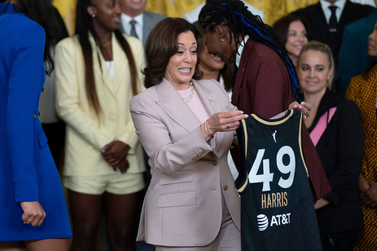 Vice President Kamala Harris shows her Las Vegas Aces jersey to her husband Doug Emhoff during ...