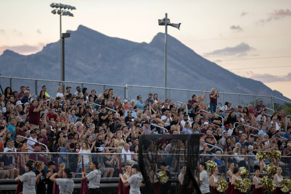 The Faith Lutheran crowd cheers for their team during a high school football game against Deser ...