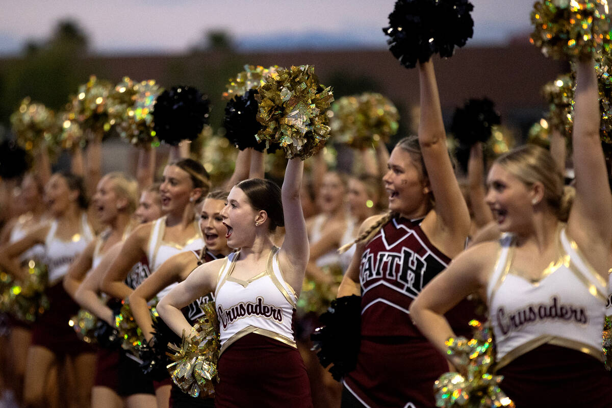 Faith Lutheran cheerleaders pump up the crowd during a high school football game against Desert ...