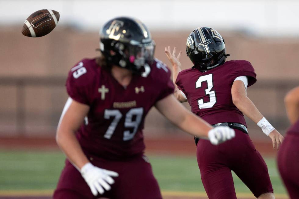 Faith Lutheran quarterback Garyt Odom (3) fumbles the ball during a high school football game a ...