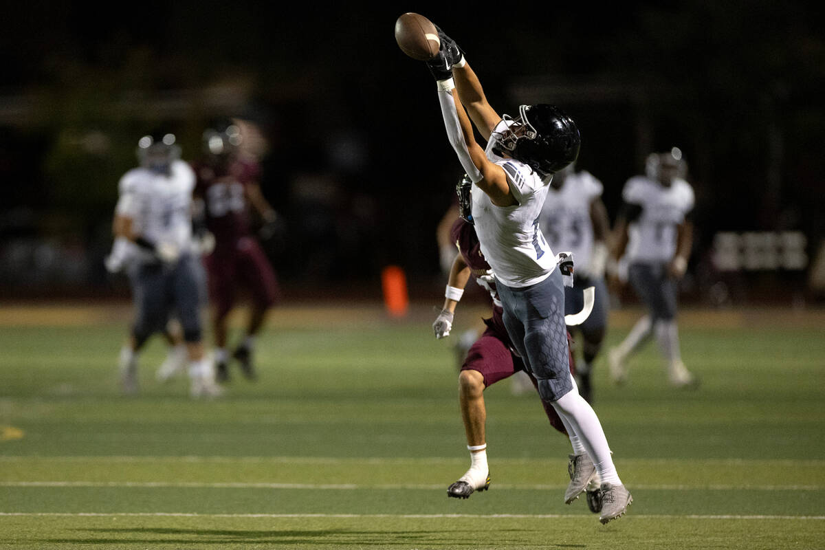 Desert Pines wide receiver Luey Jaime (19) attempts to catch while Faith Lutheran’s Bran ...