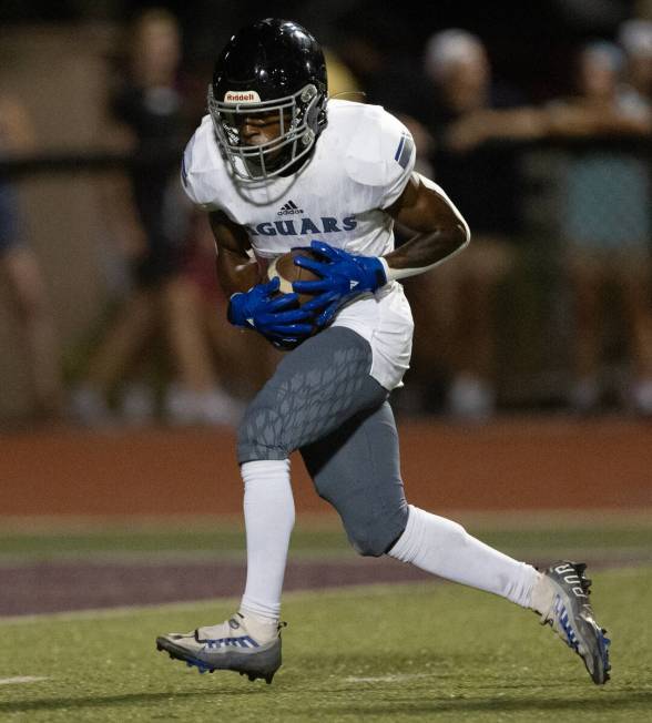 Desert Pines running back Massiah Mingo (6) pivots with his catch before scoring a touchdown du ...