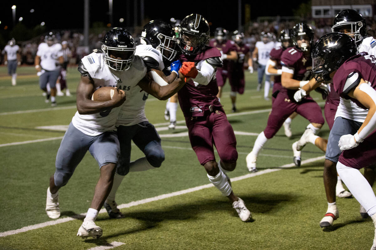 Desert Pines running back Greg Burrell (5) is pushed out of bounds during the second half of a ...