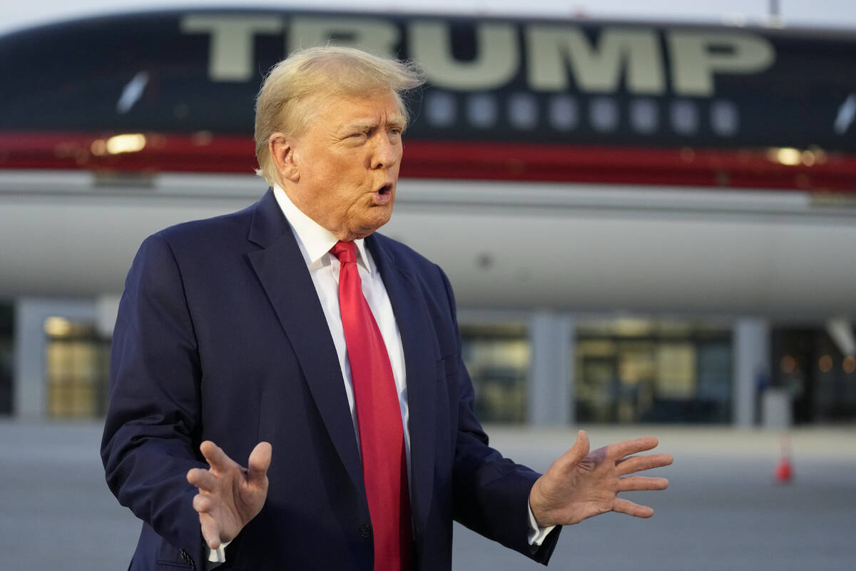 Former President Donald Trump speaks with reporters before departure from Hartsfield-Jackson At ...