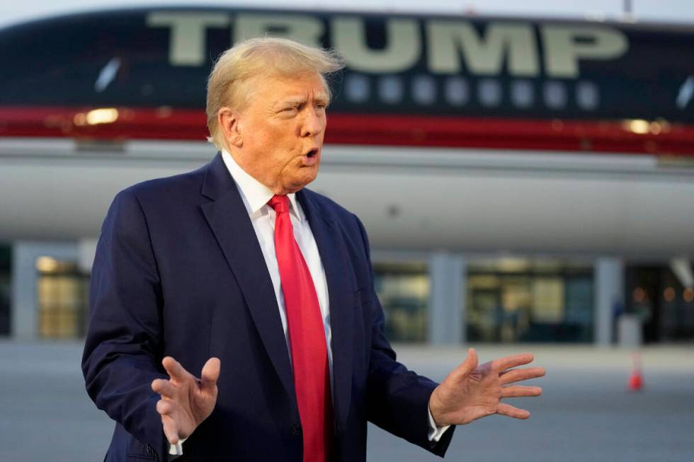 Former President Donald Trump speaks with reporters before departure from Hartsfield-Jackson At ...