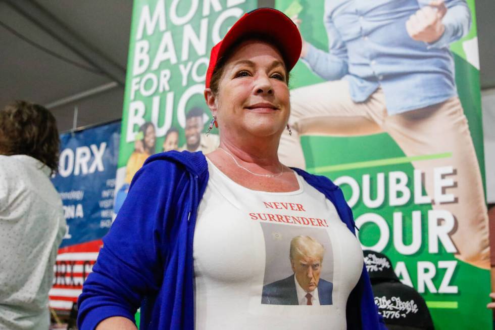 Trish LeBeu wears her homemade shirt with Donald Trump’s mugshot at the ReAwaken America Tour ...