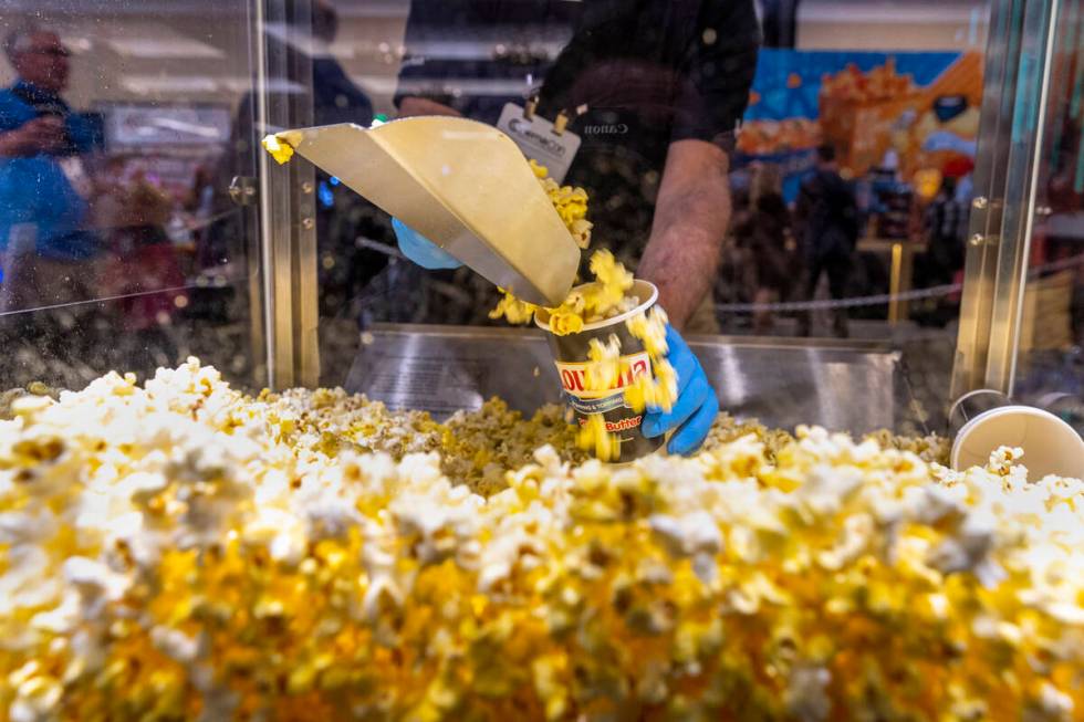 Another sample of LouAna real buttered popcorn is scooped up during CinemaCon at Caesars Palace ...