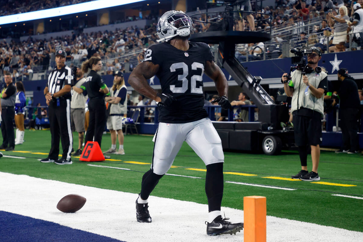 Las Vegas Raiders running back Damien Williams (32) celebrates scoring on a running play in the ...