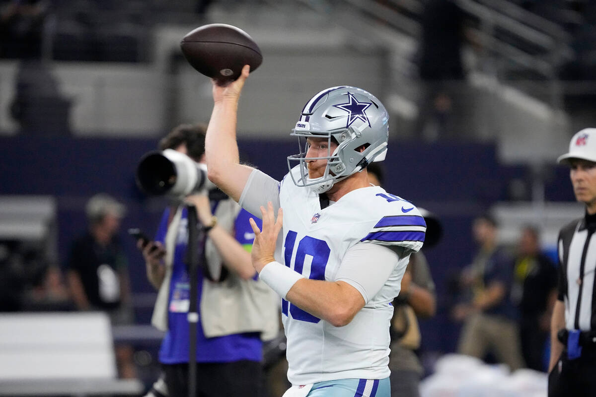 Dallas Cowboys quarterback Cooper Rush (10) warms up before the first half of a preseason NFL f ...