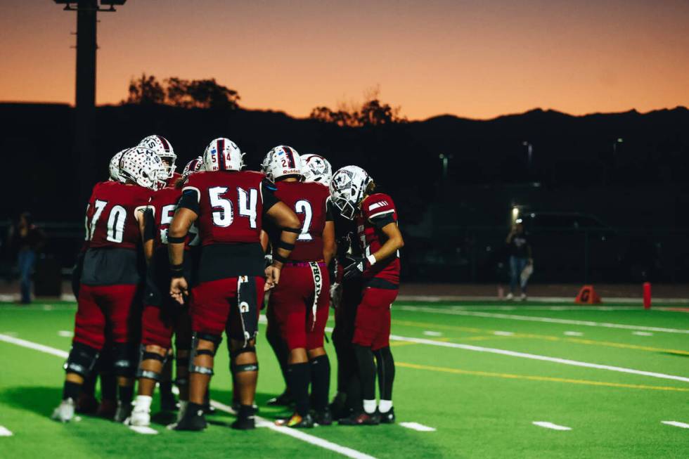 Liberty players huddle together to figure out their next moves as the sun sets above them durin ...