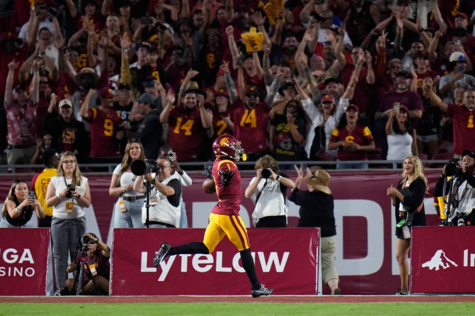 Fans cheer as Southern California wide receiver Zachariah Branch celebrates his touchdown again ...