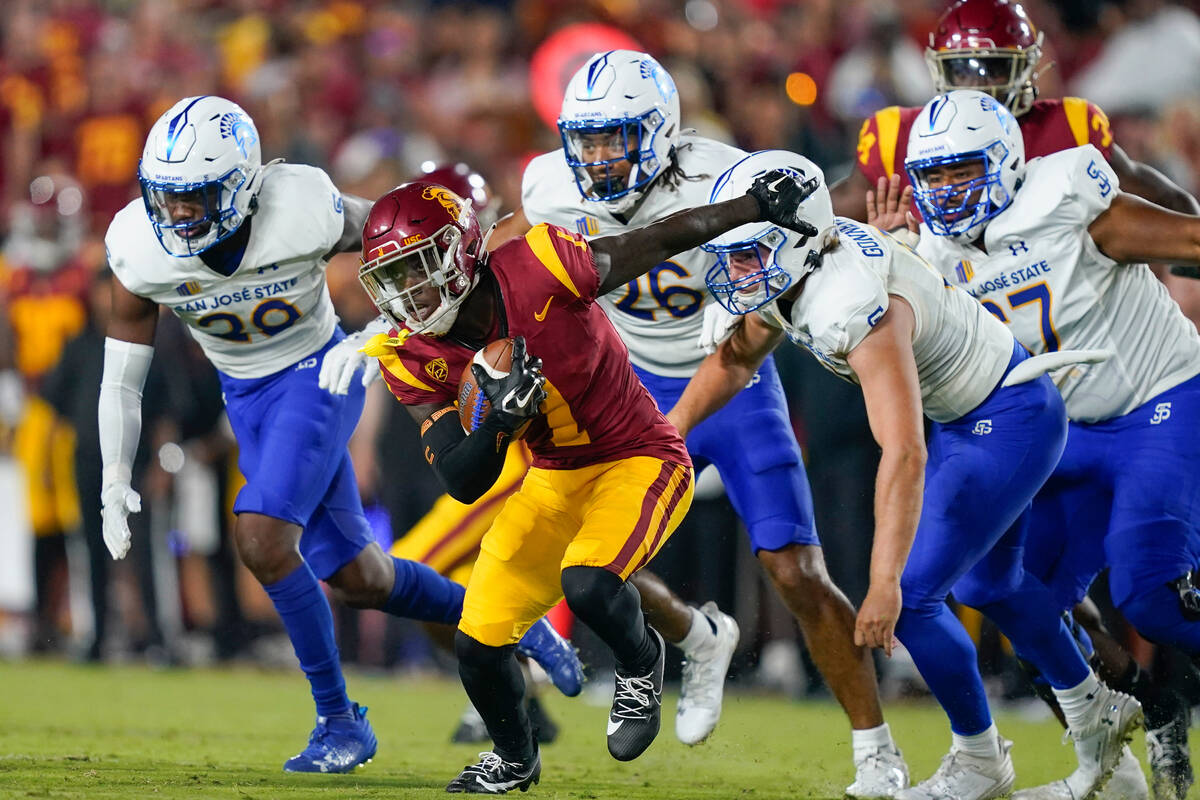 Southern California's Zachariah Branch (1) runs past San Jose State defenders while returning t ...