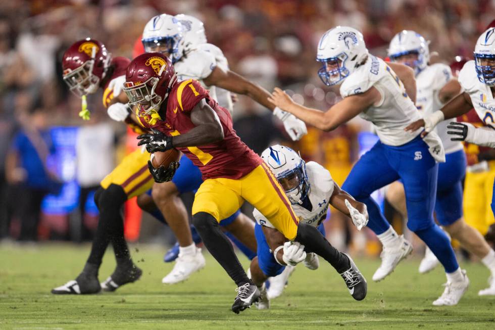 Southern California wide receiver Zachariah Branch (1) runs with the ball during an NCAA footba ...