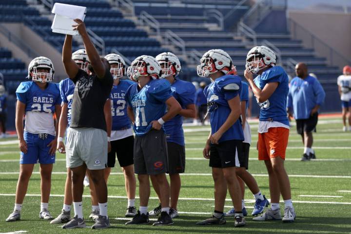 Bishop Gorman players read strategy during football practice at Bishop Gorman High School on We ...