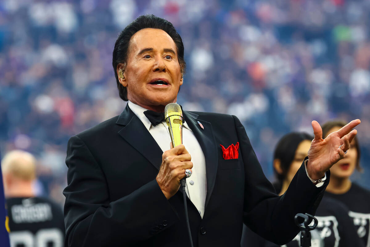 Wayne Newton performs the national anthem before an NFL preseason football game between the Rai ...