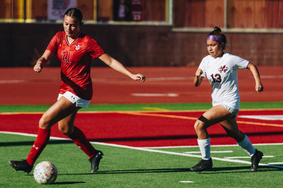 Arbor View soccer player Bridget Guevara (21) kicks the ball as Cimarron-Memorial defensive pla ...