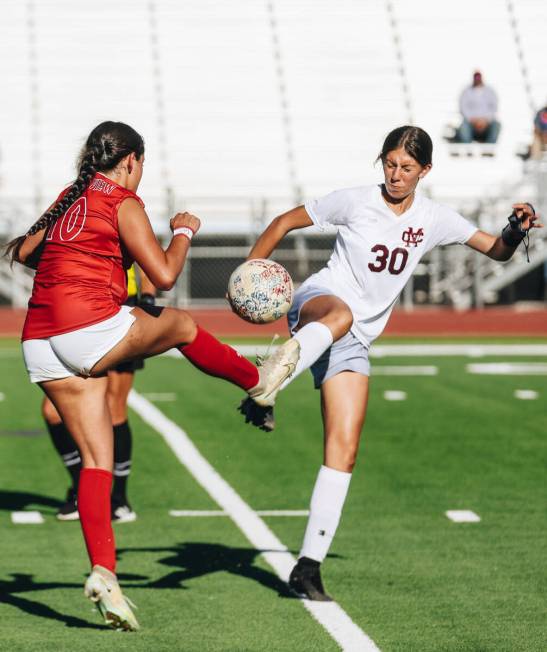 Cimarron-Memorial defensive player Alexa Alvarenga (30) kicks the ball at the same time as Arbo ...