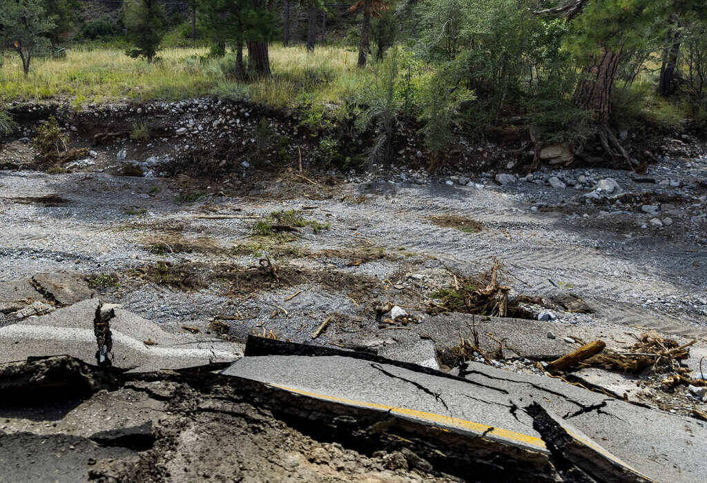 Sections of Kyle Canyon Road are crumbled or washed away as cleanup from the extensive damage o ...