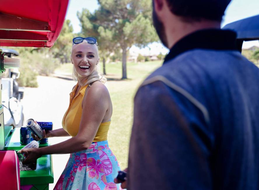 Cass Holland, a cart girl with a massive Tik Tok following, serves drinks to Chase Larson at Ch ...