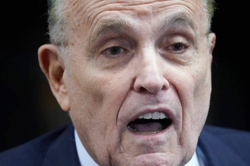 Former Mayor of New York Rudy Giuliani speaks to reporters as he leaves his apartment building ...