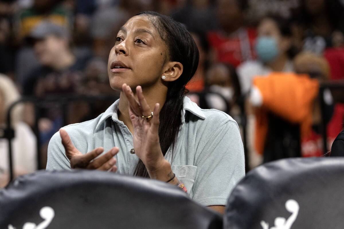 Las Vegas Aces forward Candace Parker, who is injured after having foot surgery, claps from the ...