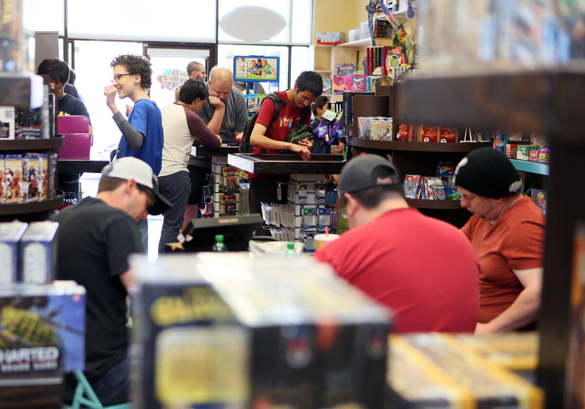 People take part in a Table Top Day event at Shall We Play? game store Saturday, April 5, 2014, ...