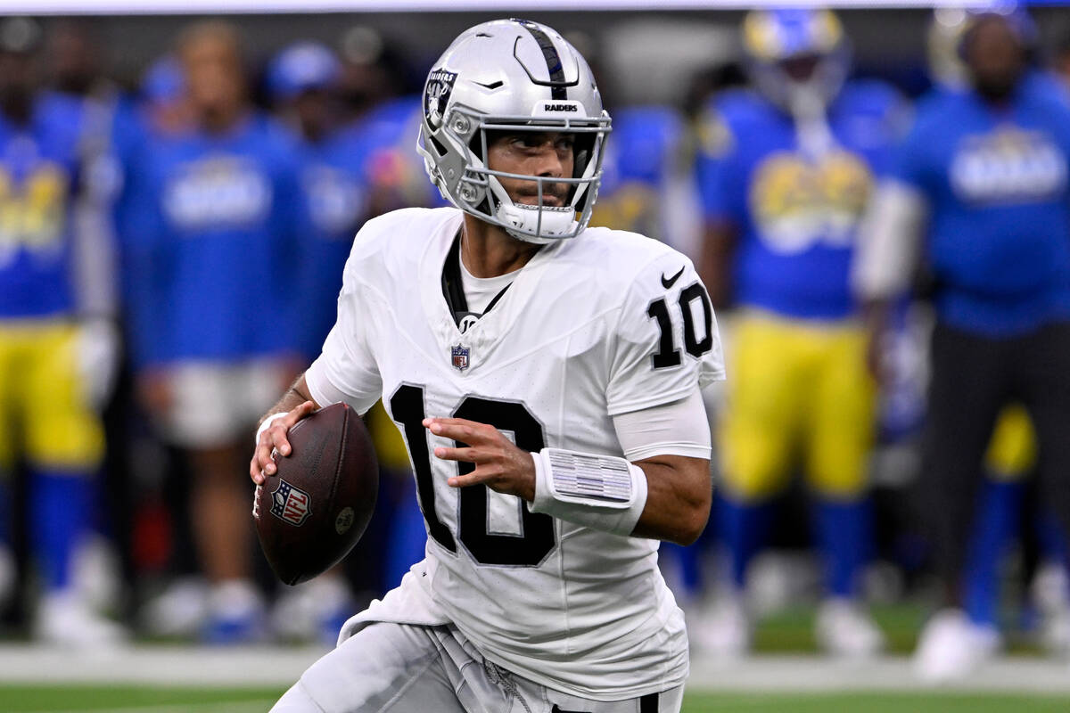 Las Vegas Raiders quarterback Jimmy Garoppolo rolls out to pass against the Los Angeles Rams du ...