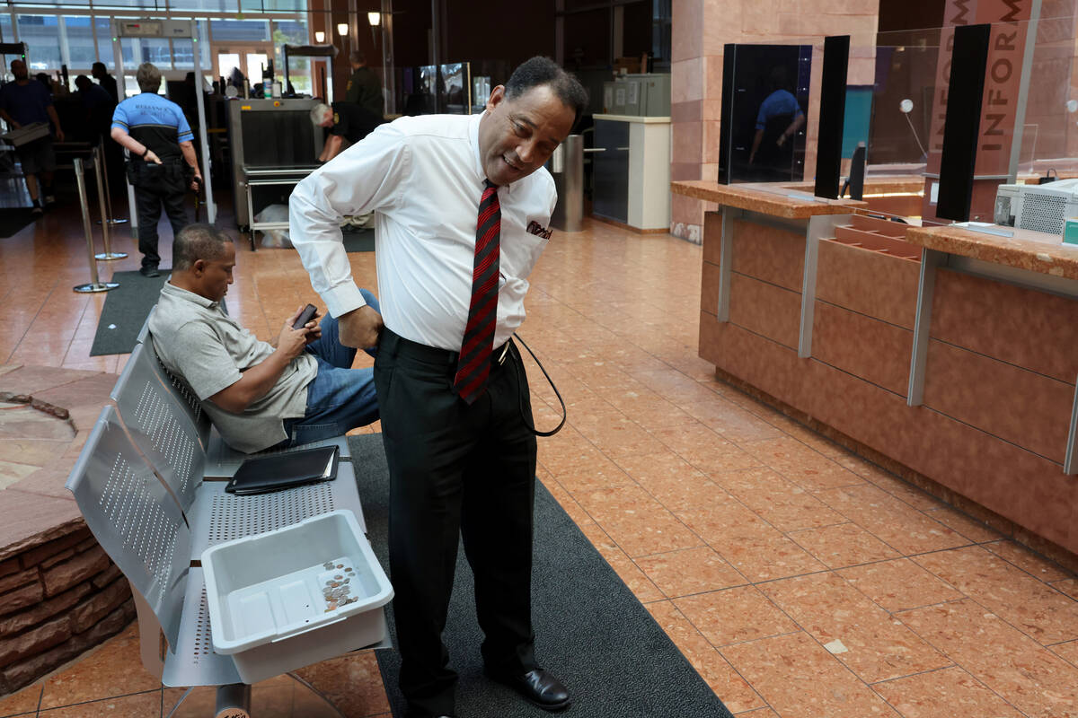 Burke Hall replaces his belt after going through security at the Regional Justice Center in Las ...