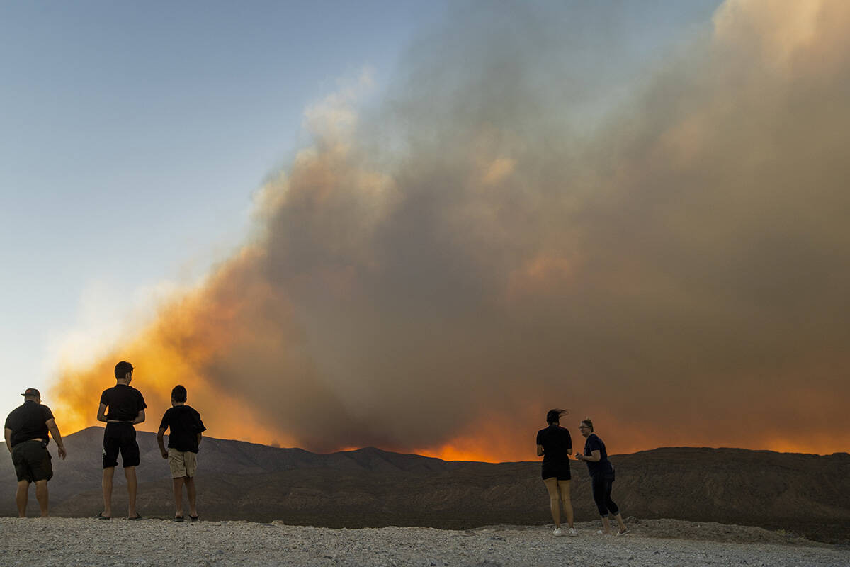 Onlookers stop to view the Mahogany Fire on Mount Charleston near a rise about Harris Spring Ro ...