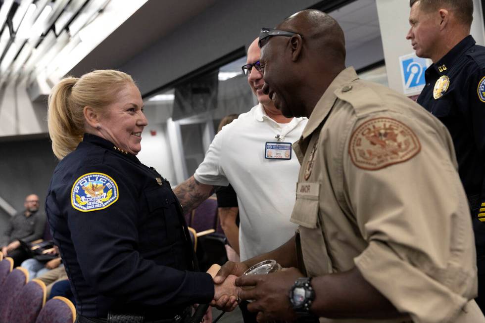 Newly appointed police chief Hollie Chadwick greets fellow officers after her swearing in cerem ...