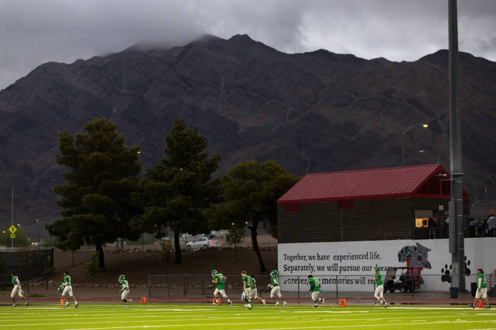 Rancho players leave the field after a lightning delay was called during the first half of a hi ...