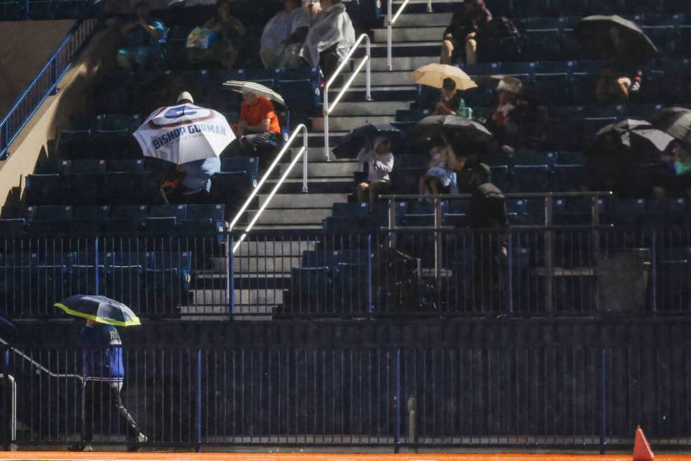 Fans wait for the rain to mellow out before the beginning of Bishop Gorman’s game agains ...