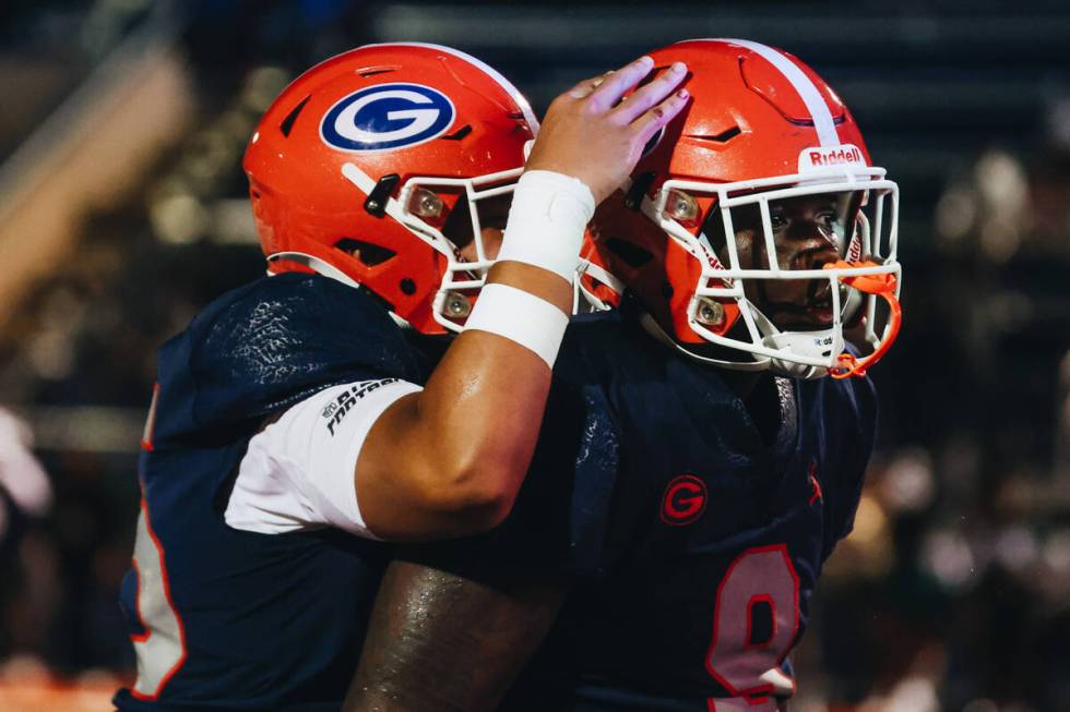 Bishop Gorman tight end Elija Lofton (9) gets a pat on the back from a teammate after making a ...