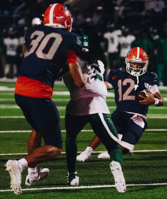 Bishop Gorman quarterback Micah Alejado (12) slides as he runs with the ball during a game agai ...