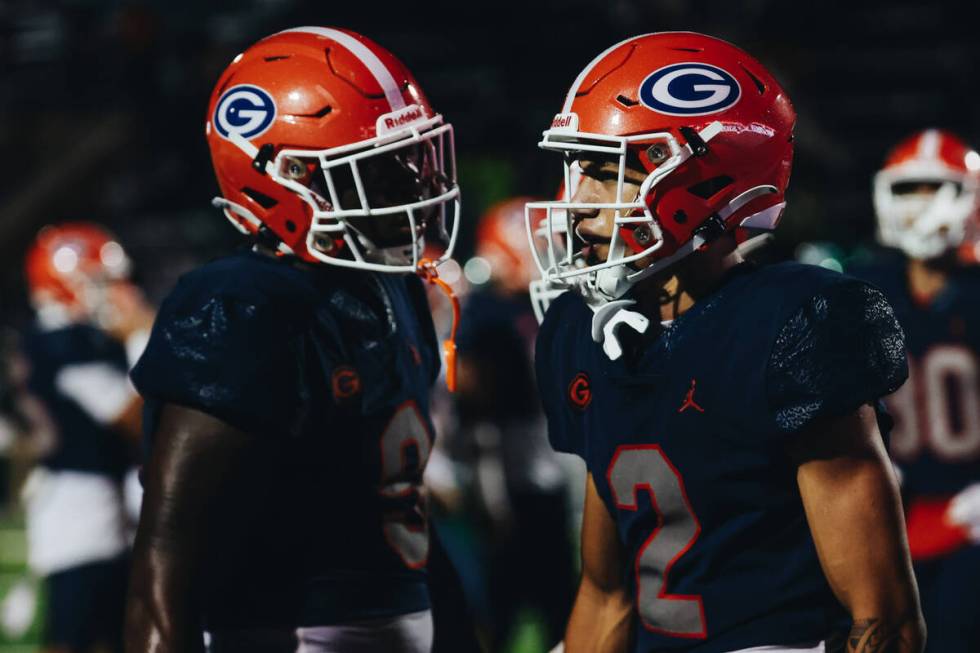 BishopGorman wide receiver Audric Harris (2) regroupes with teammate Elija Lofton (9) during a ...