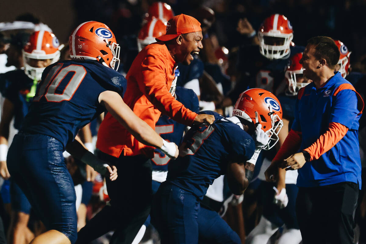 Bishop Gorman coaches and players celebrate an interception by running back Devon Rice (3) at t ...